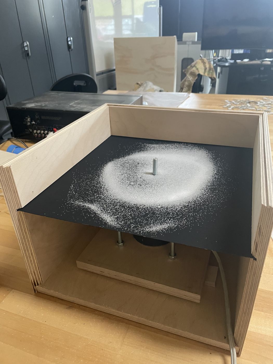 The unfinished box: sand gathering into a ring around the centre bolt