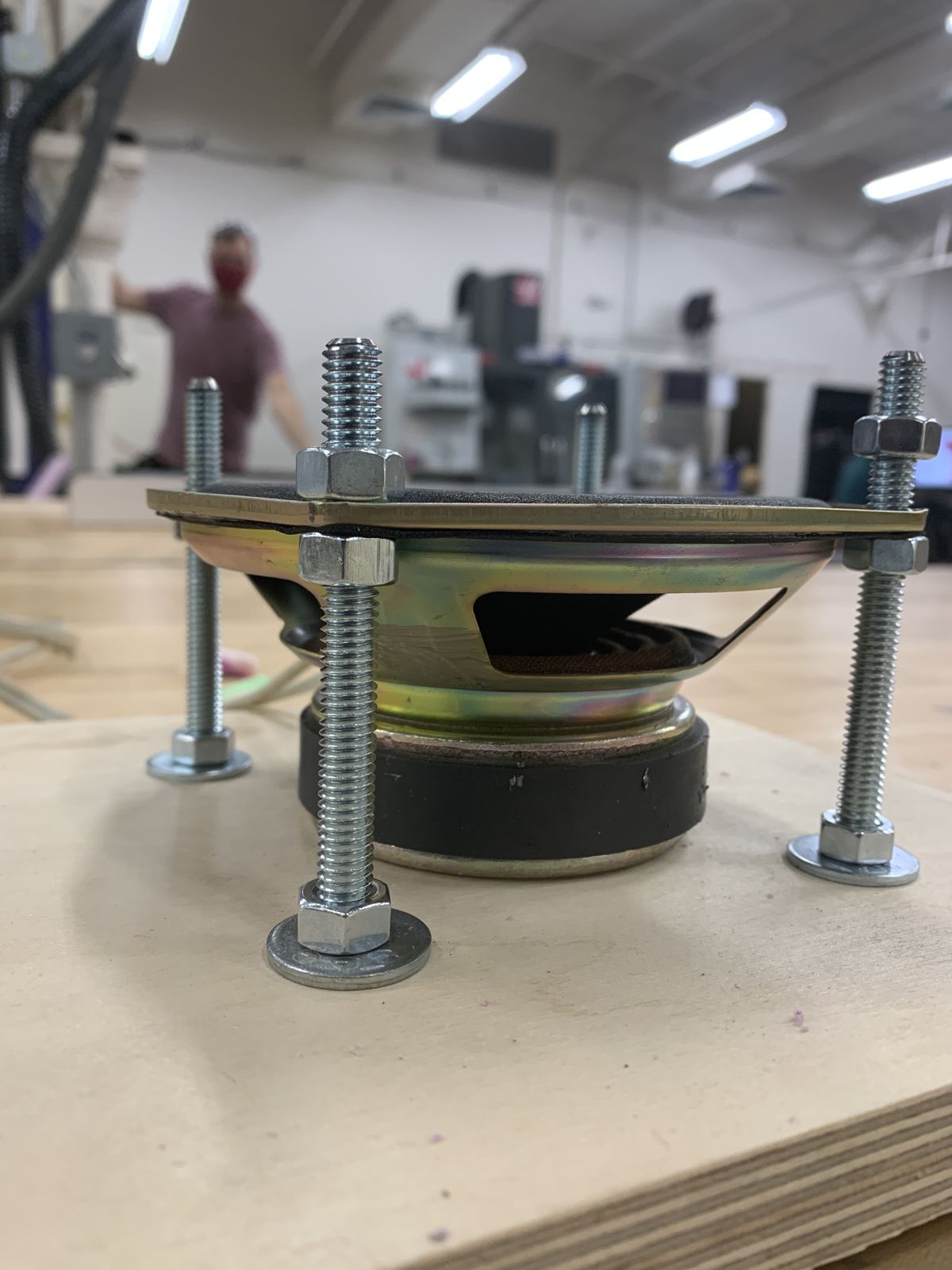 The speaker underneath the plate, held on threaded rods